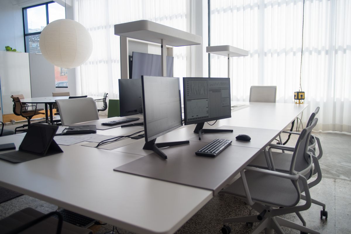 Digital workspace with monitors showing project data